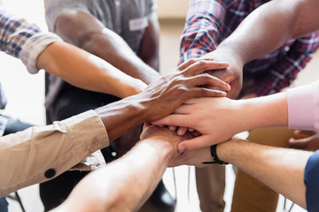 Men joining hands in huddle