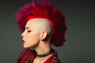 Profile portrait cool young woman with pink mohawk