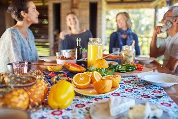 Friends enjoying healthy breakfast at table during yoga retreat