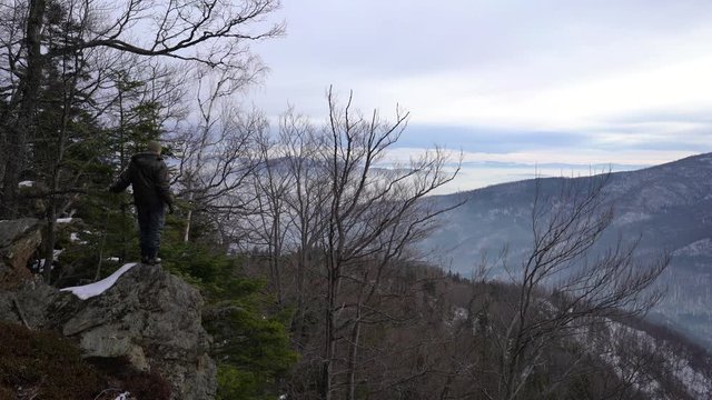 Man is watching winter landscape on mountain - (4K)