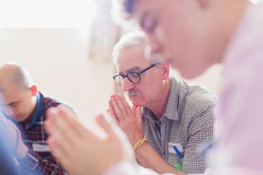 Men praying in prayer group