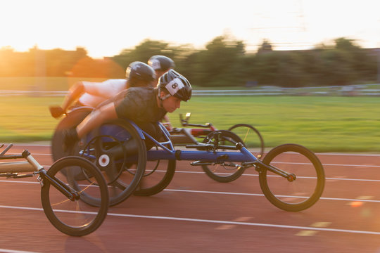 Paraplegic athletes speeding along sports track in wheelchair race