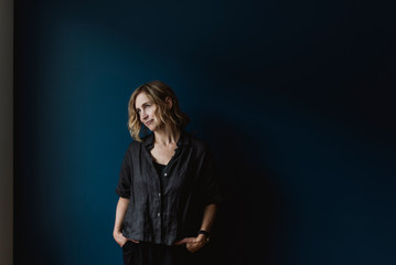 Thoughtful woman on blue background