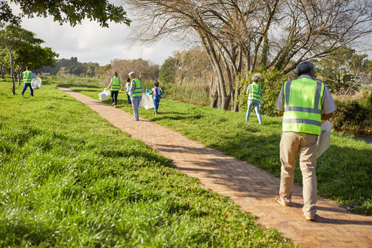 Volunteers cleaning up litter in sunny park