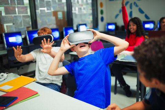 Junior high school boy students using virtual reality simulators in classroom