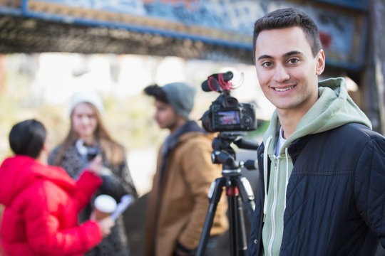 Portrait confident young man vlogging with friends