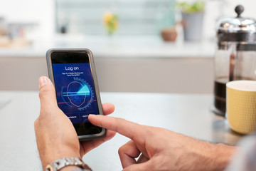 Close up man using smart phone face recognition log on