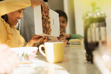 Girl pouring breakfast cereal into bowl