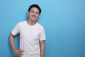Happy young Asian man smiling at camera