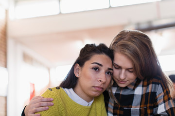 Young woman consoling friend