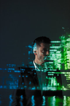 Double exposure thoughtful businessman against cityscape at night