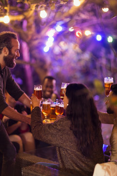 Friends Drinking Beer At Garden Party