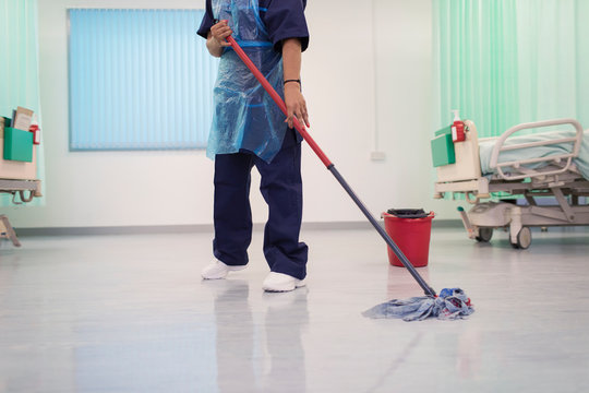 Female Orderly Mopping Hospital Ward Floor