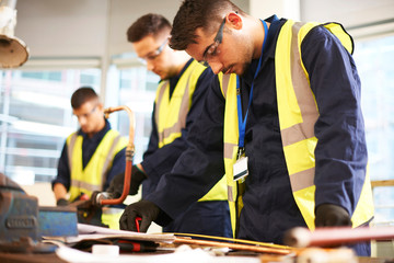 Focused male students in shop class workshop