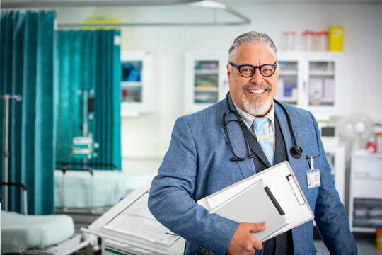 Portrait confident senior male doctor making rounds in hospital