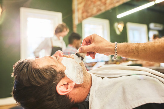 Man getting a shave at barbershop