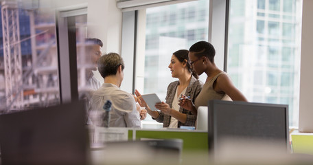 Business people with digital tablet talking, meeting in office