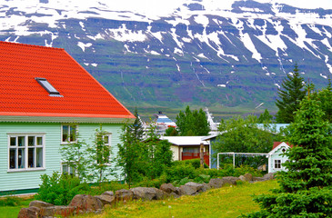 Classic cruiseship or cruise ship liner is docked in town of Seydisfjordur on Iceland with local...