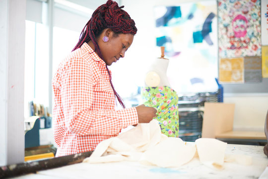 Female Fashion Designer With Fabric In Studio