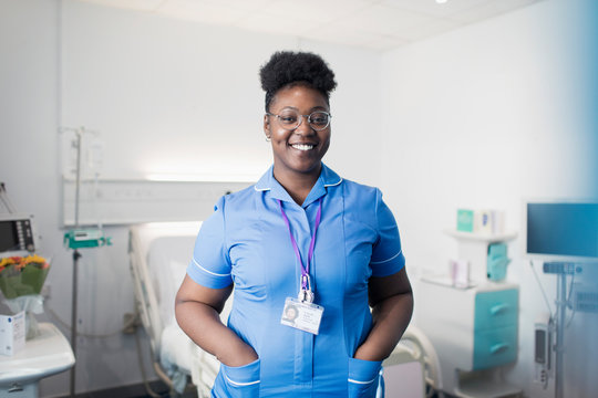 Portrait confident, smiling female nurse in hospital room