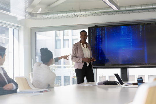 Businesswoman leading conference room meeting