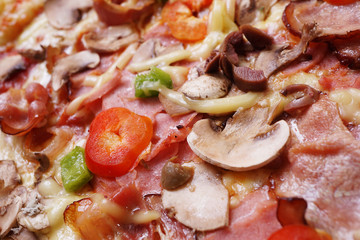 Close up of fresh baked pizza with prosciutto and bacon