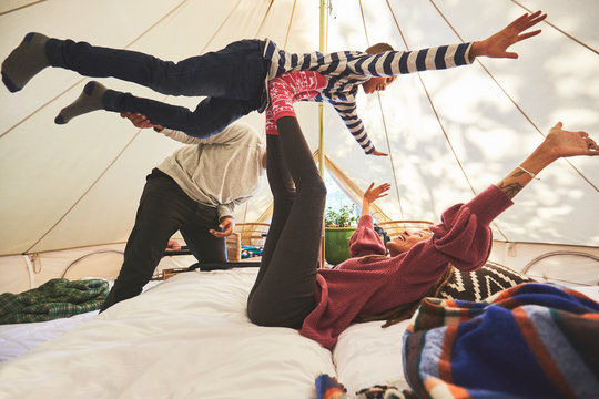 Playful family in camping yurt - Powered by Adobe