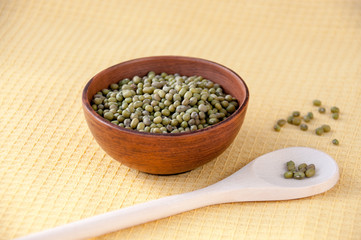 Grits mash in a clay bowl and a wooden spoon on the table