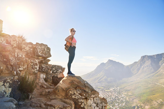 Young female hiker on sunny cliff Cape Town South Africa