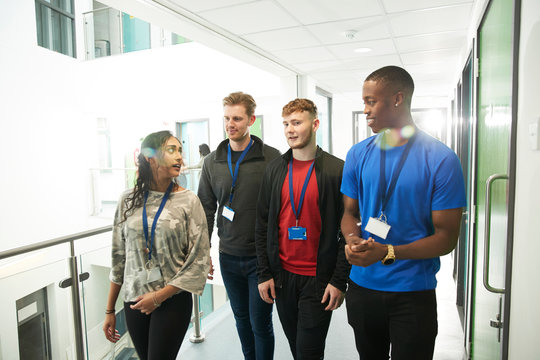 College students talking and walking in corridor