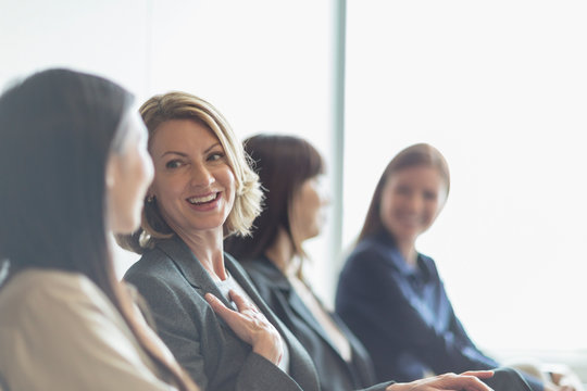 Smiling businesswomen talking