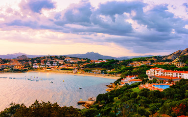 Fototapeta premium Landscape and scenery of Baja Sardinia luxury resort in at sunset evening, Sardegna island in Italy in summer. Olbia province. Villas And Mediterranean sea. Mixed media.