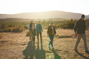 Safari tour guide leading group on sunny wildlife reserve South Africa