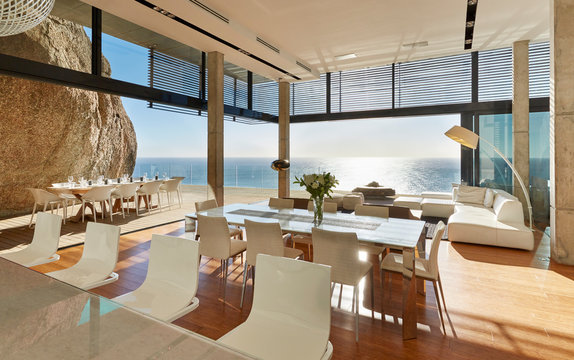 Modern luxury home showcase dining room and living room with sunny ocean view