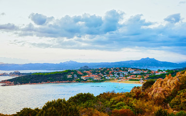 Landscape and scenery of Baja Sardinia luxury resort in at sunset evening, Sardegna island in Italy in summer. Olbia province. Villas And Mediterranean sea. Mixed media.