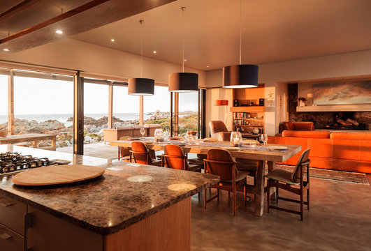 Sunny home showcase interior overlooking ocean