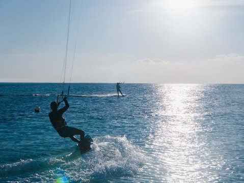 Parasailing on ocean under sunny blue sky