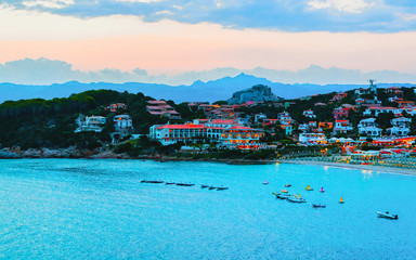 Fototapeta premium Landscape and scenery of Baja Sardinia luxury resort in at sunset evening, Sardegna island in Italy in summer. Olbia province. Villas And Mediterranean sea. Mixed media.