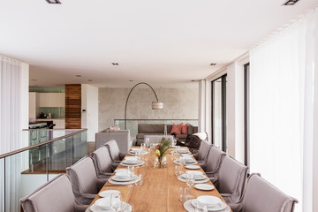 Modern, luxury home showcase interior dining room with placesettings on dining table