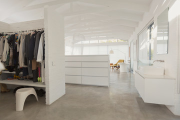 White, modern, minimalist walk-in closet and bathroom vanity