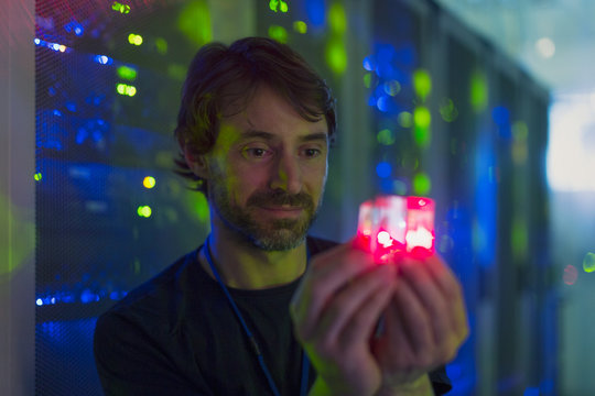 Server room technician holding glowing cube