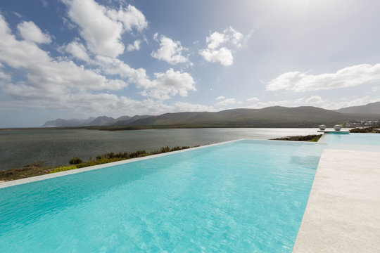 Sunny, tranquil infinity pool with ocean view