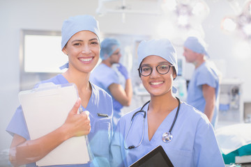 Portrait smiling, confident female surgeons in operating room