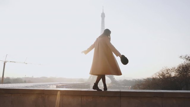 Side view beautiful happy tourist woman walking, dancing at romantic sunrise Eiffel Tower scenery in Paris slow motion.
