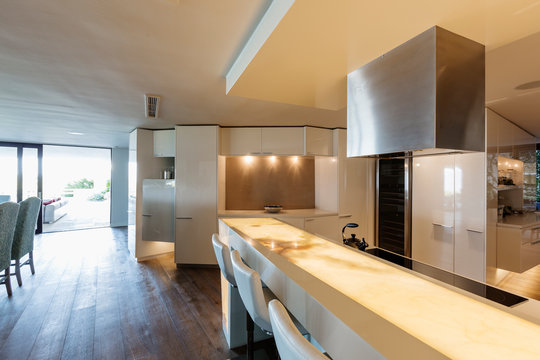 Illuminated, modern, minimalist luxury home showcase interior kitchen
