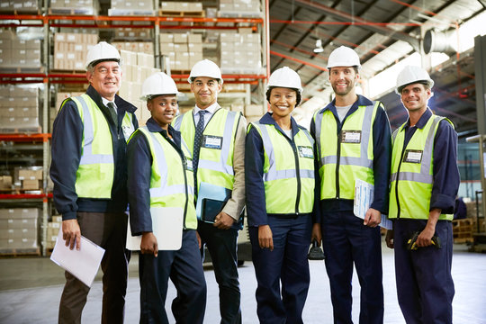 Portrait confident managers and workers in distribution warehouse - Powered by Adobe