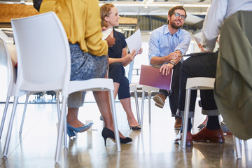 Business people talking in meeting circle