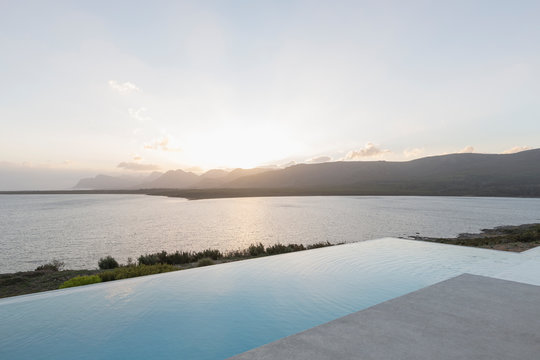 Tranquil sunset beyond infinity pool and ocean