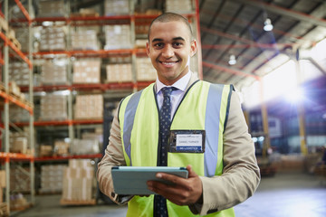 Portrait confident manager with digital tablet in distribution warehouse