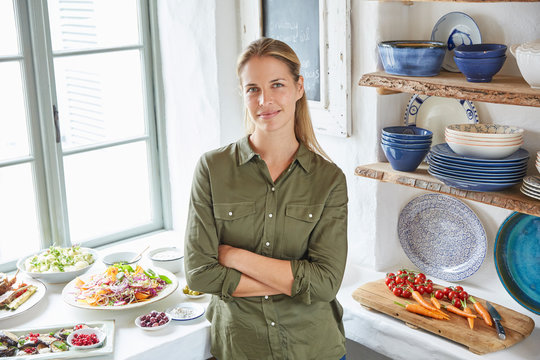 Portrait smiling woman at buffet table